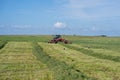 Lithuanian farmer prepare hay rows