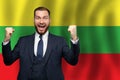 Lithuanian happy businessman on the background of flag of Lithuania Business, education, degree and citizenship concept