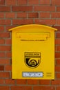 The Lithuanian mailbox hangs on a brick wall