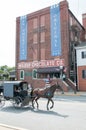 LITITZ, PA - AUGUST 30: Amish horse and buggy riding past the famed Wilbur Chocolate Company headquarters on Route 501 Royalty Free Stock Photo