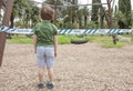Litle boy standing front playgrounds taped off