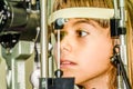 Litlle girl taking the eye exam test Royalty Free Stock Photo