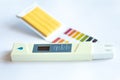 Litmus pH test with color scale and digital conductivity tester Royalty Free Stock Photo