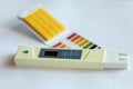 Litmus pH test with color scale and digital conductivity tester Royalty Free Stock Photo