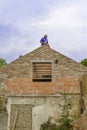 Litovel, Czech Republic August 3th 2018, Builder standing on a roof timber construction and finishing brick gable of an