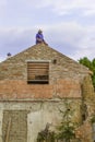Litovel, Czech Republic August 3th 2018, Builder standing on a roof timber construction and finishing brick gable of an