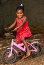 Littel african girl on bicycle.