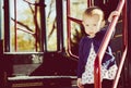 Littel Girl Stands on Playground Equipment