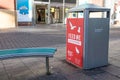 Litter bin with `Feed Me not the Birds` poster campaign slogan on the side on a shopping street Royalty Free Stock Photo