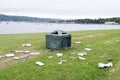 Litter garbage rubbish in park outside of bin lying on ground green grass ruin view seaside resort uk