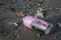 Pink graffiti spray can on dirty ground. Royalty Free Stock Photo