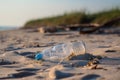 littering and urban pollution in the natural environment, with broken glass and plastic bottle on a beach