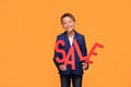 Littl elegant boy with sale letters.