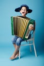 Little accordion player on blue background Royalty Free Stock Photo