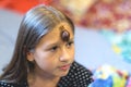 Little Achatina snail on the forehead of a cute little girl