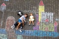 Little active kid boy and cute toddler baby girl drawing knight castle and fortress with colorful chalks on asphalt Royalty Free Stock Photo