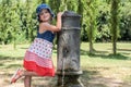 Little adorable baby girl drinks water from the drinking fountain of the roman nose on the streets of Rome Royalty Free Stock Photo