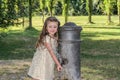 Little adorable baby girl drinks water from the drinking fountain of the roman nose on the streets of Rome Royalty Free Stock Photo