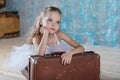 Little adorable ballerina in white tutu with old vintage suitcas Royalty Free Stock Photo