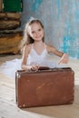 Little adorable ballerina in white tutu with old vintage suitcas Royalty Free Stock Photo