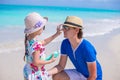 Little adorable girl applying sun cream to her father nose Royalty Free Stock Photo