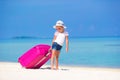 Little adorable girl with big bag on white beach Royalty Free Stock Photo