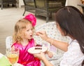 Little adorable girl celebrating 3 years birthday and eat cake.