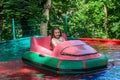 Little adorable girl child rides a boat in the amusement park Royalty Free Stock Photo