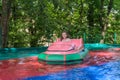 Little adorable girl child rides a boat in the amusement park Royalty Free Stock Photo