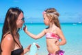 Little adorable girl gets sun cream on her Royalty Free Stock Photo