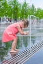 Little adorable girl have fun in street fountain Royalty Free Stock Photo