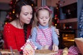 Little adorable girl and mother baking Christmas Royalty Free Stock Photo