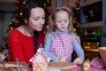 Little adorable girl and mother baking Christmas Royalty Free Stock Photo