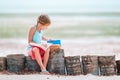 Little adorable girl reading book during tropical white beach Royalty Free Stock Photo