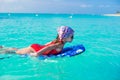 Little adorable girl on a surfboard in the