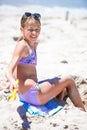 Little girl at tropical white beach making sand castle Royalty Free Stock Photo