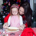 Little adorable girl and young mother baking Royalty Free Stock Photo