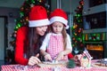 Little adorable girl and young mother baking Royalty Free Stock Photo