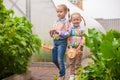 Little adorable girls with the basket of harvest near greenhouse Royalty Free Stock Photo