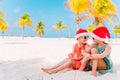 Little adorable girls in Santa hats during beach Christmas vacation having fun together Royalty Free Stock Photo