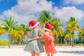 Little adorable girls in Santa hats during beach vacation have fun together Royalty Free Stock Photo