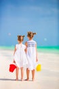 Little adorable girls walking with beach toys during tropical vacation Royalty Free Stock Photo