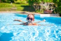 Little adorable happy girl swims in the swimming Royalty Free Stock Photo