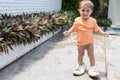 Little adorable toddler baby trying on adult sneakers