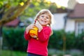 Little adorable toddler girl playing with ball outdoors. Happy smiling child catching and throwing, laughing and making Royalty Free Stock Photo