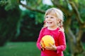 Little adorable toddler girl playing with ball outdoors. Happy smiling child catching and throwing, laughing and making Royalty Free Stock Photo