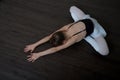 A little adorable young ballerina doing stretching exercises Royalty Free Stock Photo