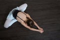 A little adorable young ballerina doing stretching exercises on Royalty Free Stock Photo