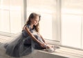 A little adorable young ballerina in a playful mood in the inter Royalty Free Stock Photo