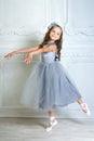 A little adorable young ballerina in a playful mood in the inter Royalty Free Stock Photo